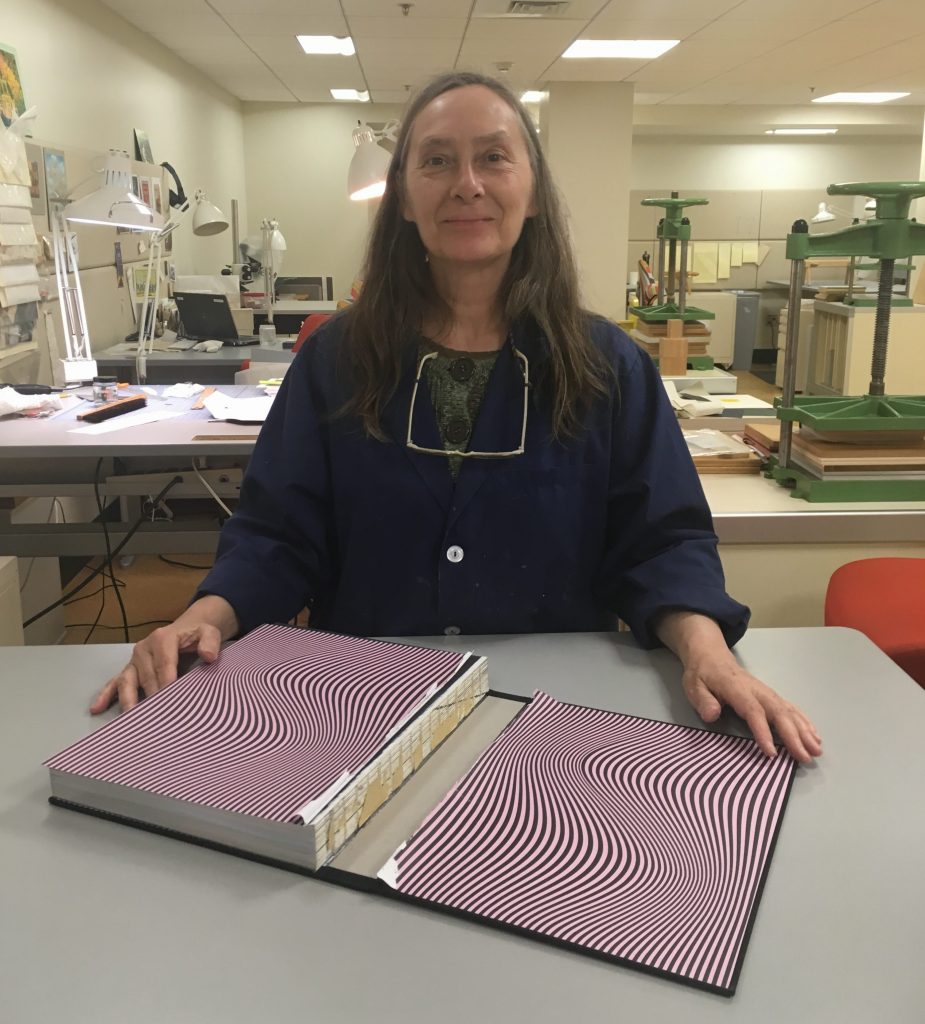 Mary Yordy displays a damaged case binding, ready for repair. 