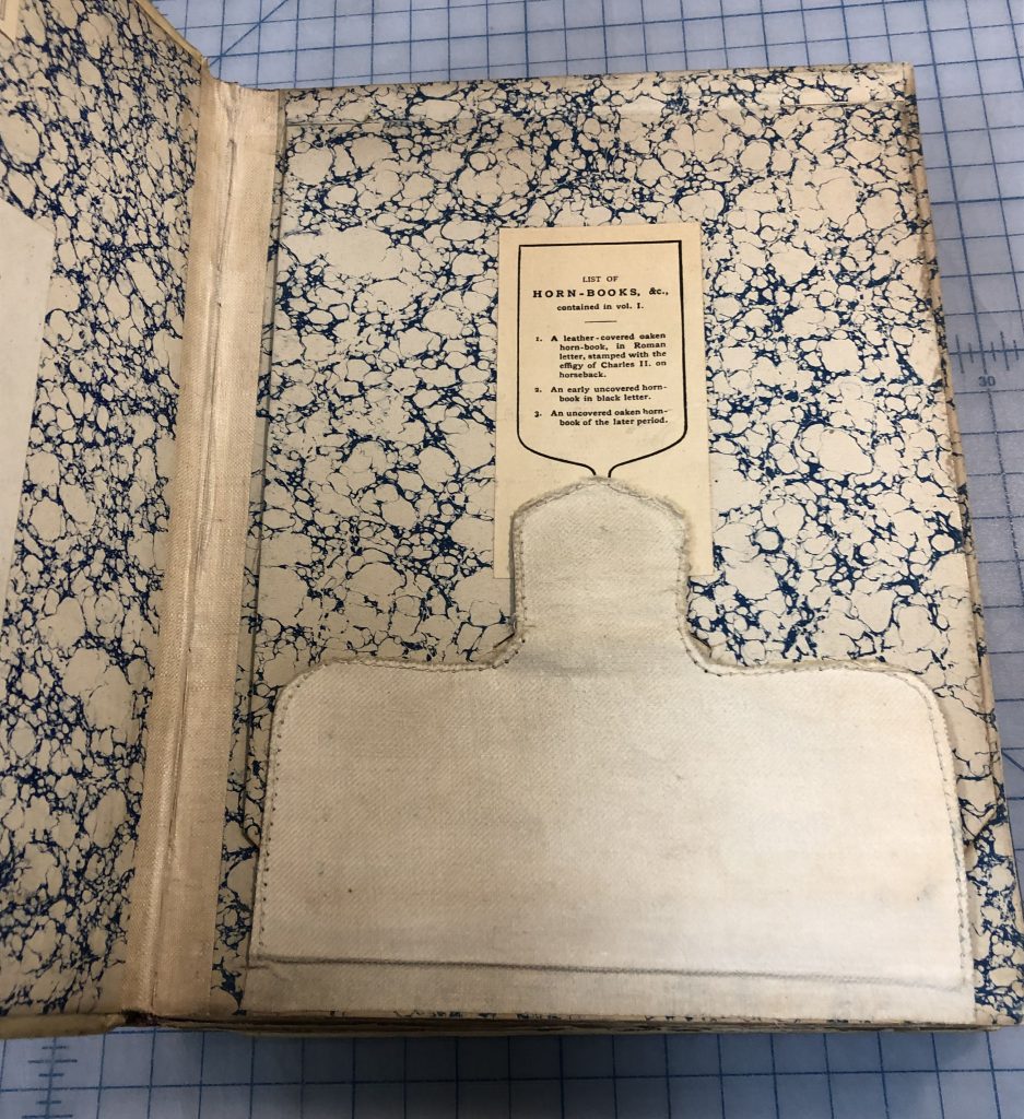 cover of the hidden compartment with a label describing the contents.