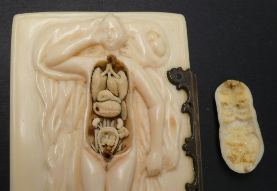 The model open, showing individually carved ivory pieces inside.