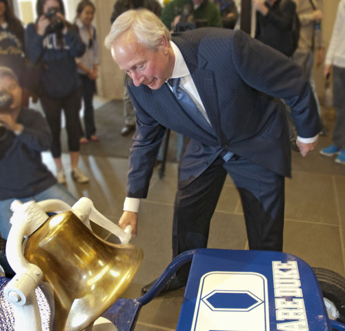 President Brodhead rings the Victory Bell.