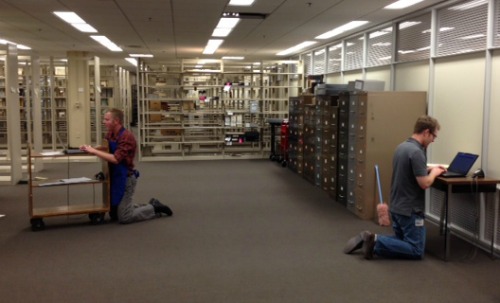 Joshua Larkin Rowley and Noah Huffman: too busy checking materials into our new stacks to find a chair.