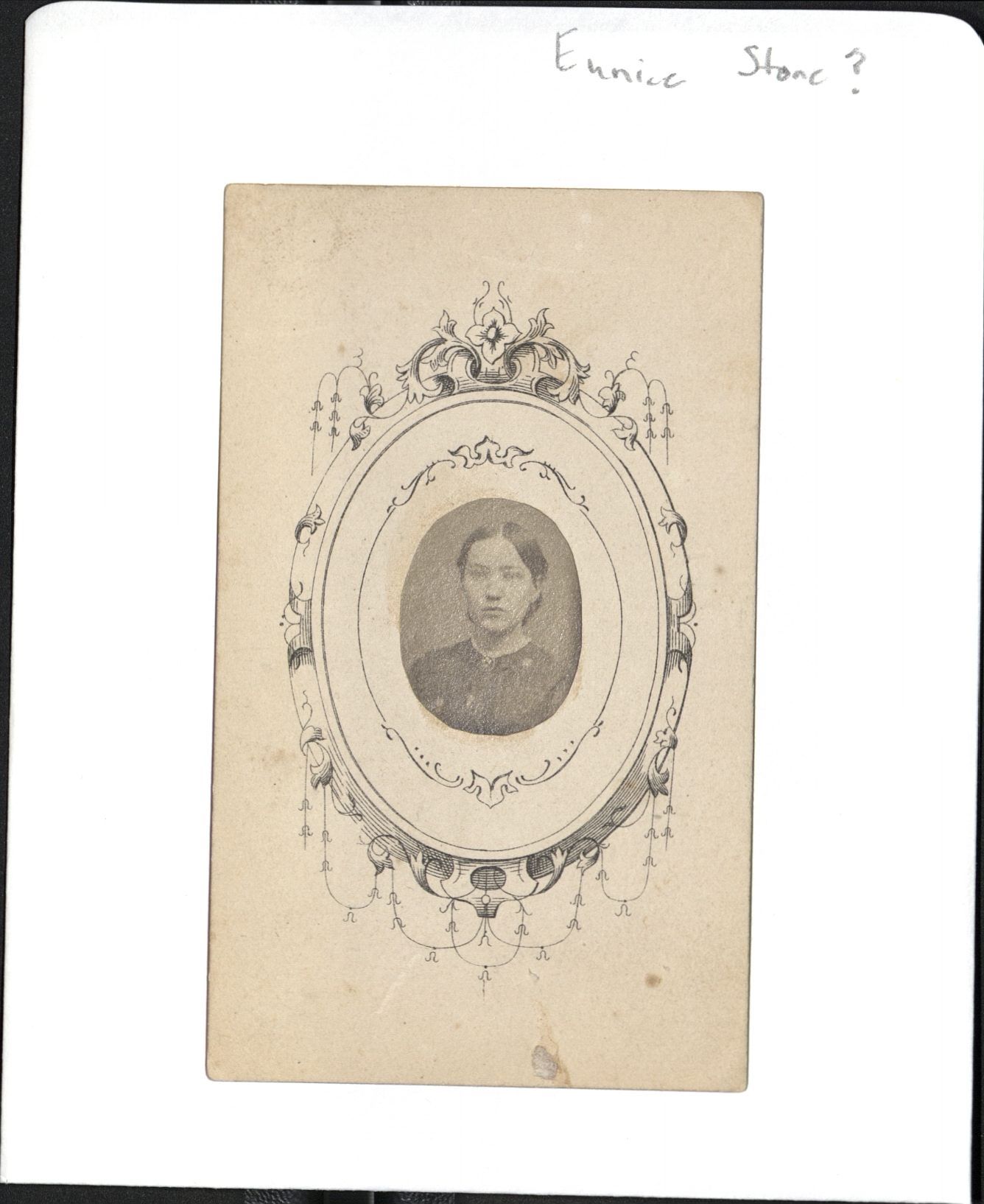 Small 19th century black and white photo of a woman pasted on a decorated card.