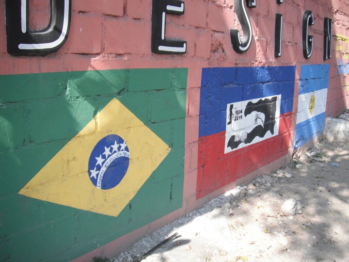 Flags painted on a brick wall.