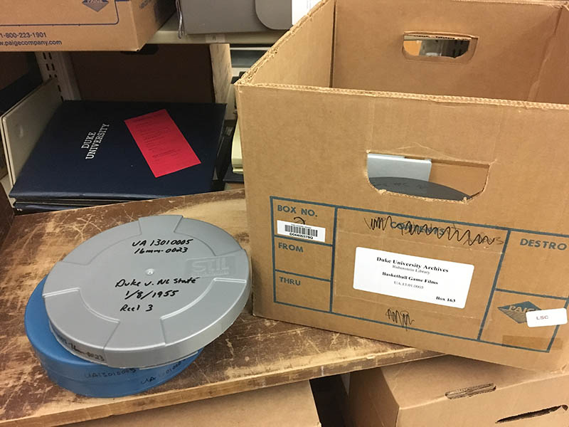 Color photo of a Paige box and two film cans from our Game Films collections.