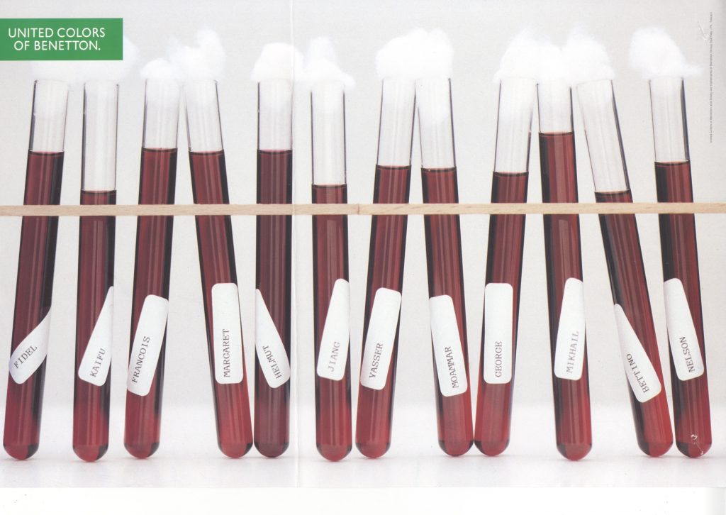 Color Benetton advertisement, showing vials of blood. The vials are each labeled with a different. The names are ethnically diverse and include Fidel, Kaifu, Helmut, Jiang, George, and Mikhail. 