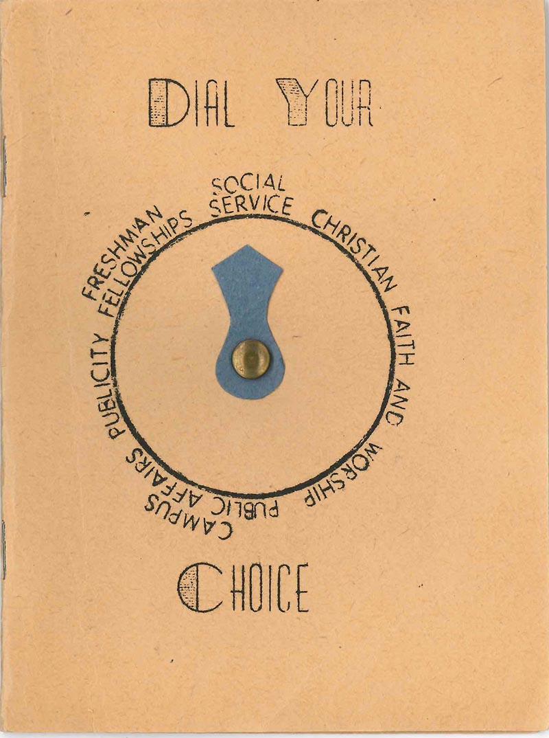 Cover of a 1930s YWCA handbook for first-year students. The cover is tan construction paper and bears the title "Dial Your Choice." A dial with a blue spinning pointer is in the center of the cover; the dial choices are freshman fellowships; social service; Christian faith and worship; campus public affairs; and publicity.