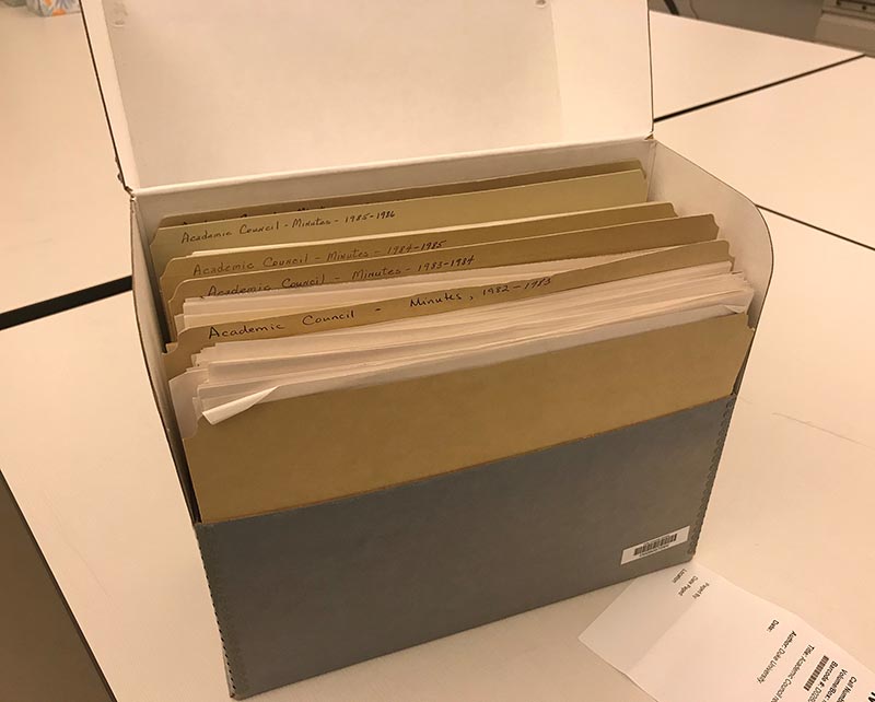 An opened Hollinger box showing folders from the Academic Council records.