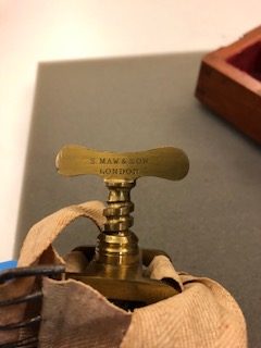 image of tourniquet included in amputation set that show the name of the manufacturer, S. Maw & Son.