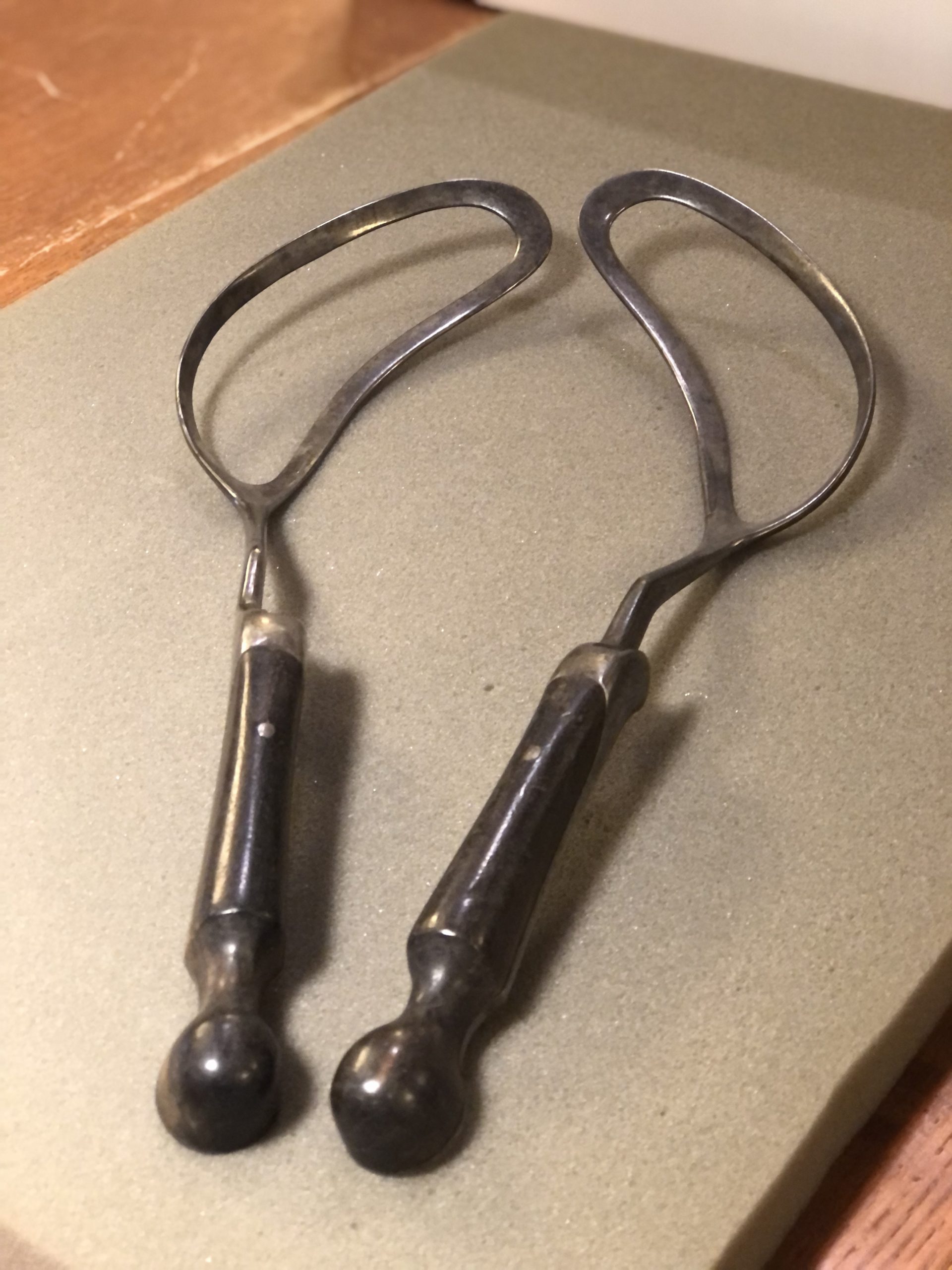 a pair of metal forceps