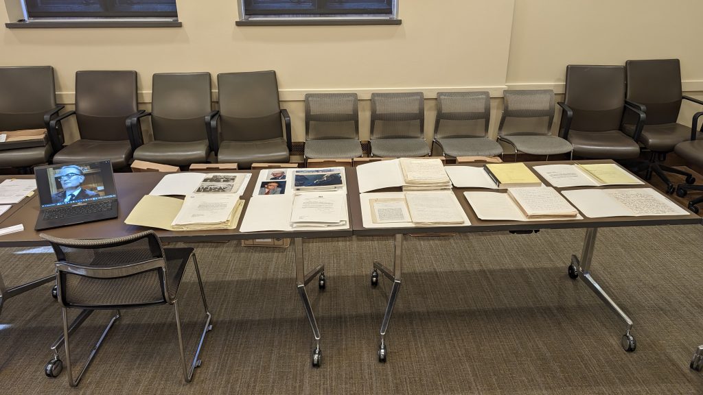 A table with folders and documents laid out on top of it.