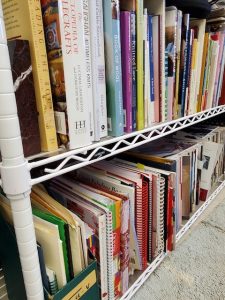 Photo of needlework-related books on Jacquie's shelves
