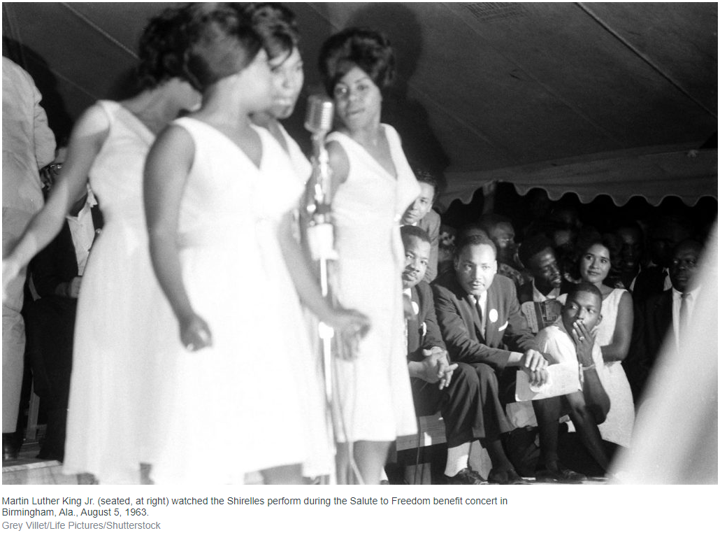 Image from "March on Washington: Rare Photos of a Star-Studded Fundraiser, 1963" from life.comMartin Luther King Jr. (seated, at right) watched the Shirelles perform during the Salute to Freedom benefit concert in Birmingham, Ala., August 5, 1963. Credit: Grey Villet/Life Pictures/Shutterstock