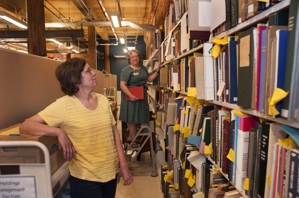 Smith Warehouse: Lynda Baptist (left), Head of Holdings Management, and Lois Schultz, Catalog Librarian for Monographic Resources, work their way through books and periodicals originally cataloged in the Dewey Decimal system that need to be updated and reclassified in the Library of Congress system. The reclassification of the Libraries’ holdings began in 2004. Of the several million volumes that had to be reclassified, only a few thousand remain, representing the most intricate and time-consuming items to catalog.