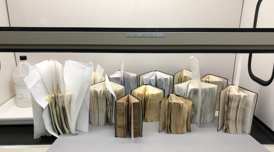 Books drying under a fume hood in conservation lab