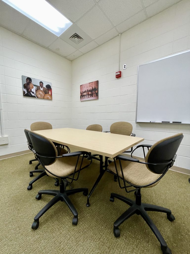 Photograph of group study room in the Music Library with table, 6 chairs, and whiteboard