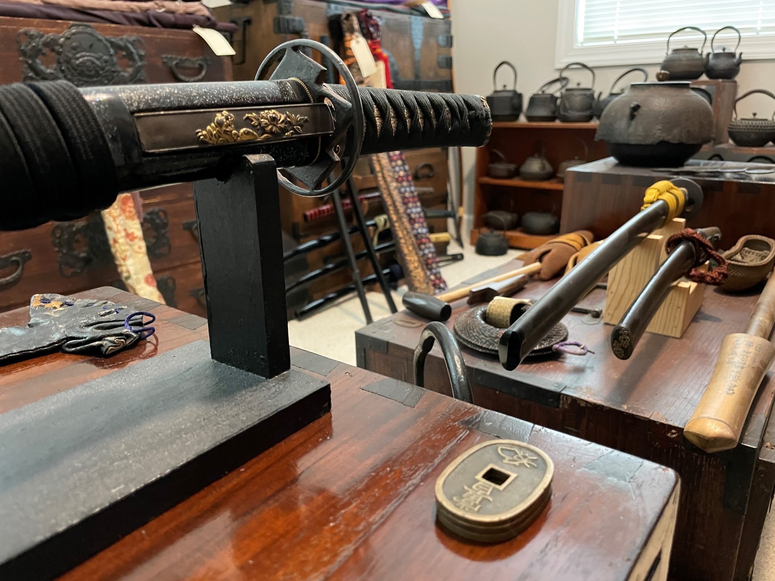 Samurai sword and related artifacts displayed around a room.